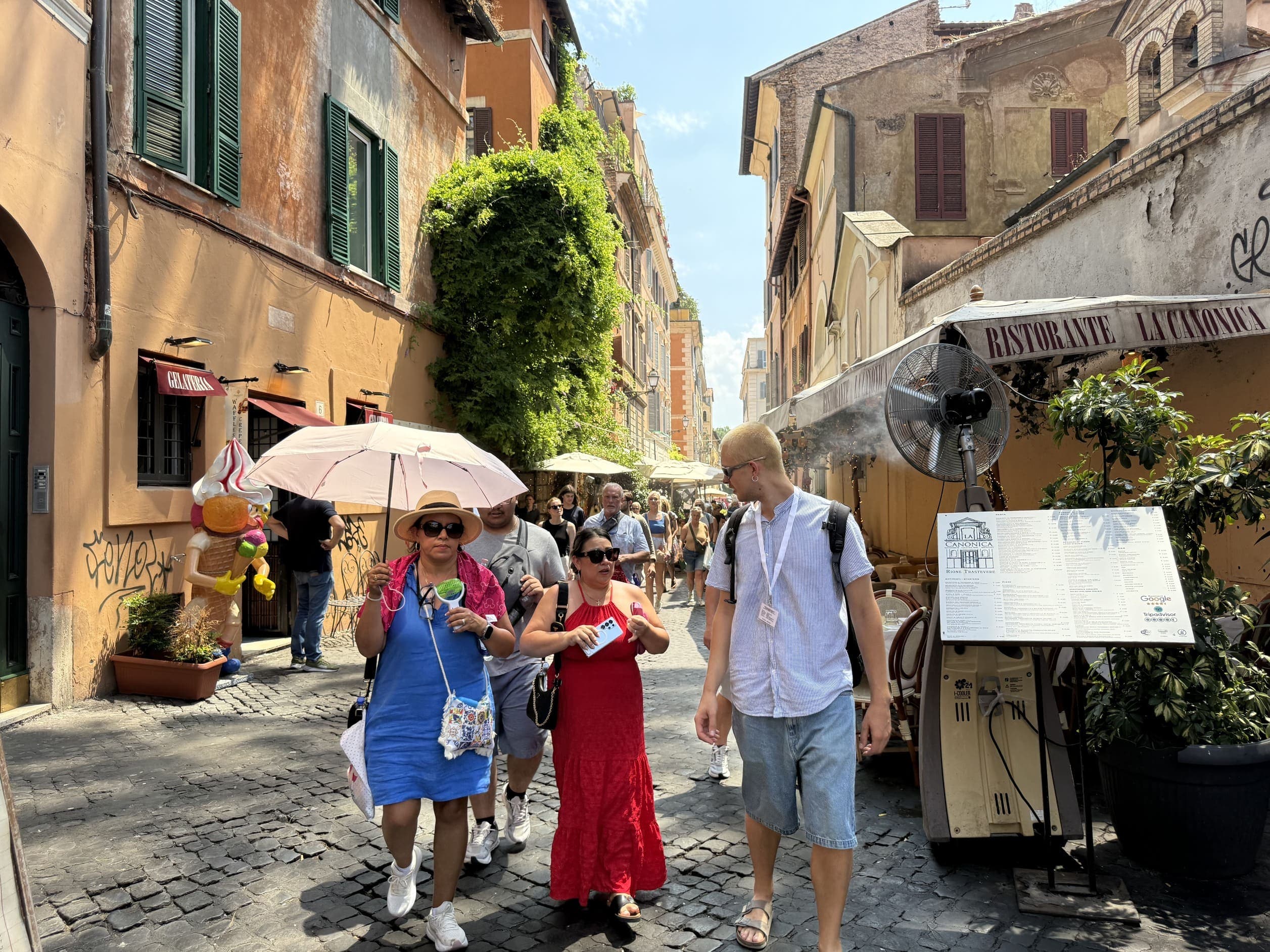 A guide and a small group walking along a street in Trastevere