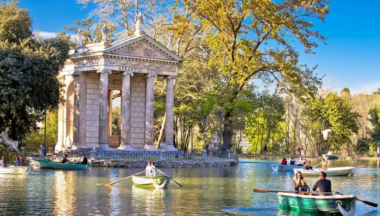 Rowboats on the small lake in Villa Borghese with the Temple of Aesculapius on its little island